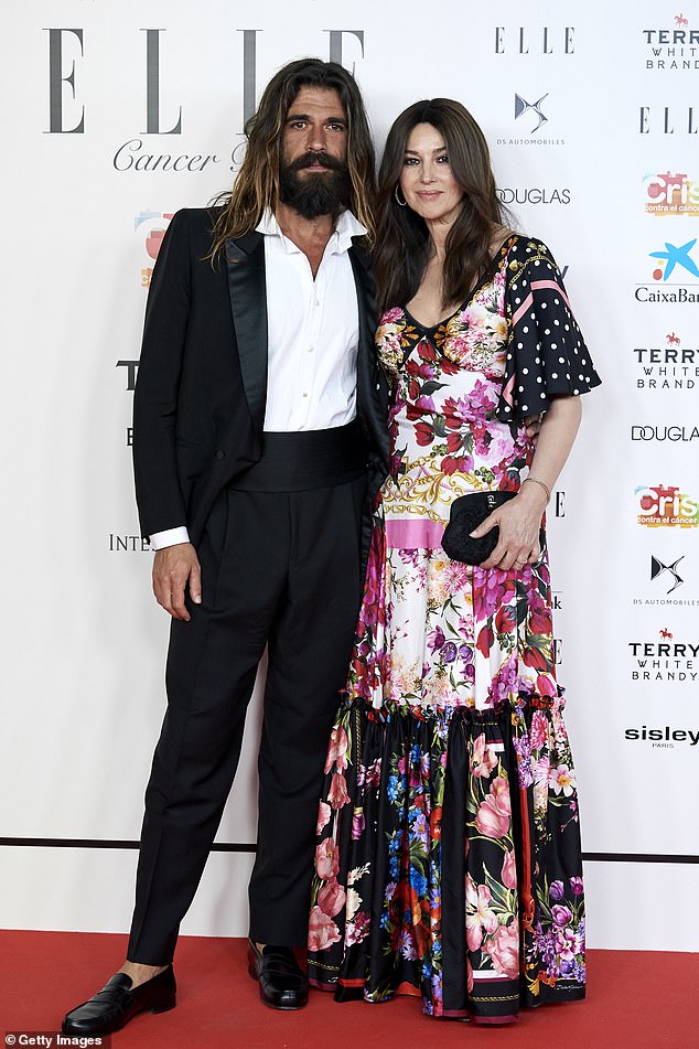 Lovebirds: Monica Bellucci, 54, dazzled in a quirky floral print dress as she joined her boyfriend Nicolas Lefebvre, 36, at the ELLE Charity Gala in Madrid, Spain on Thursday