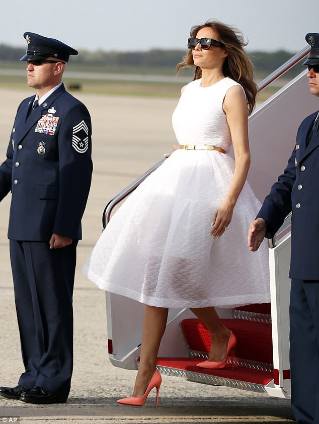 Flowing: Melania stepped off Air Force One in a fit and flare classic Simone Rocha white dress with a gold belt as she arrived at Andrews Air Force Base in April 2017