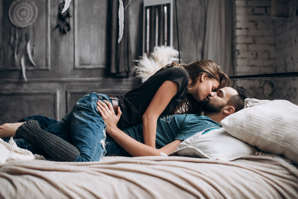 Couple spending time together relaxing on the bed and kiss each other - The Virgo man’s erogenous zones